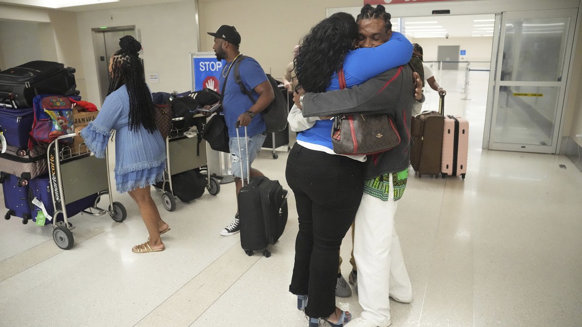 Valerie Laveus greets her brother Reginald Malherbe Daniel as he arrives for the first time to...